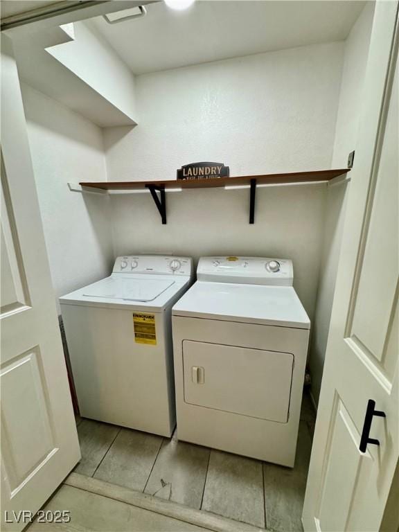 1320 Driscoll Dr Unit 202, Las Vegas, NV 89128 - washroom with washer and dryer and light tile patterned floors