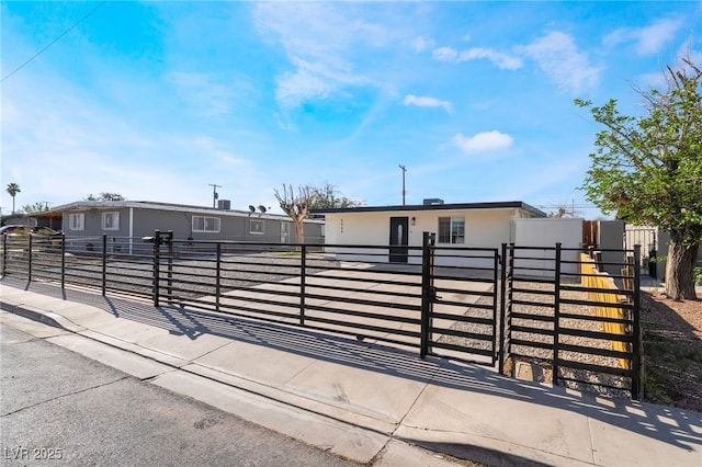 5069 Hallet Dr, Las Vegas, NV 89122 - view of front of house with a fenced front yard, stucco siding, and a gate
