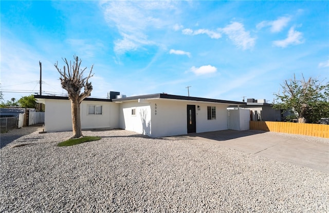 5069 Hallet Dr, Las Vegas, NV 89122 - view of front facade featuring stucco siding, concrete driveway, and a patio area