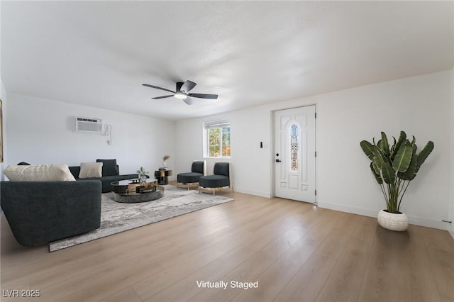 5069 Hallet Dr, Las Vegas, NV 89122 - living area with a wall unit AC, ceiling fan, wood finished floors, and baseboards