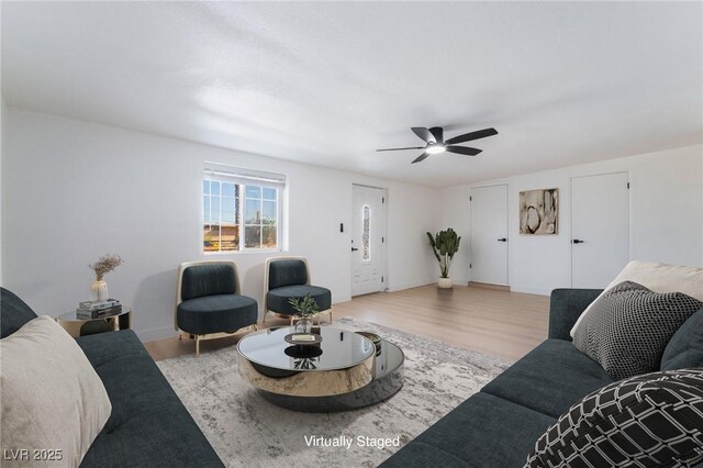 5069 Hallet Dr, Las Vegas, NV 89122 - living room with wood finished floors, a ceiling fan, and baseboards