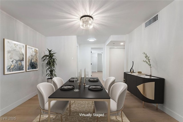 5069 Hallet Dr, Las Vegas, NV 89122 - dining room with a chandelier, wood finished floors, and baseboards