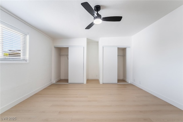 5069 Hallet Dr, Las Vegas, NV 89122 - unfurnished bedroom featuring multiple closets, light wood-style flooring, baseboards, and a ceiling fan