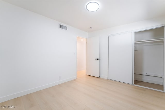 5069 Hallet Dr, Las Vegas, NV 89122 - unfurnished bedroom featuring light wood-style flooring, a closet, and baseboards