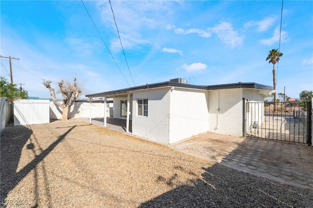 5069 Hallet Dr, Las Vegas, NV 89122 - rear view of property featuring a fenced backyard, a patio area, concrete block siding, and a gate