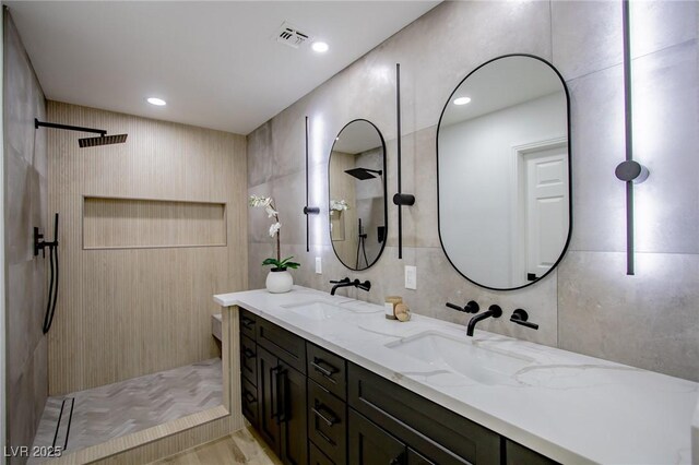 10025 Netherton Dr, Las Vegas, NV 89134 - bathroom with tile walls, walk in shower, and double vanity