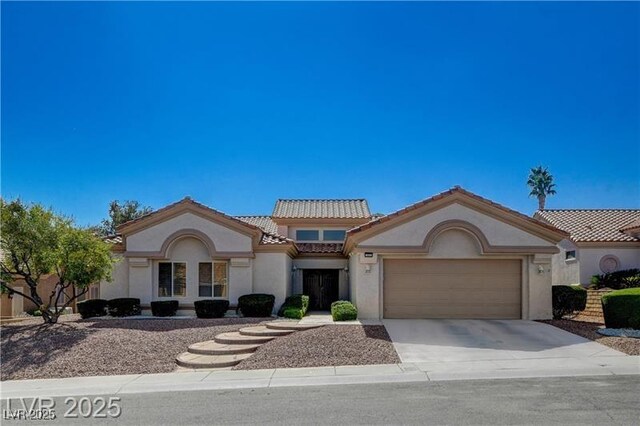 10025 Netherton Dr, Las Vegas, NV 89134 - mediterranean / spanish home with stucco siding, driveway, a tile roof, and an attached garage