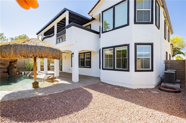 25 Blue Valley Dr, Henderson, NV 89002 - rear view of house featuring stucco siding, a balcony, a patio, and central AC