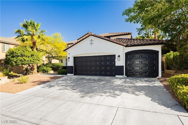 25 Blue Valley Dr, Henderson, NV 89002 - mediterranean / spanish-style house with a garage, stucco siding, driveway, and a tiled roof