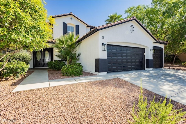 25 Blue Valley Dr, Henderson, NV 89002 - mediterranean / spanish house featuring an attached garage, stucco siding, a tile roof, and concrete driveway