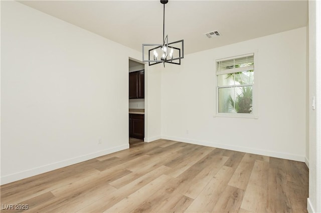 25 Blue Valley Dr, Henderson, NV 89002 - unfurnished dining area with a chandelier, light wood finished floors, and baseboards