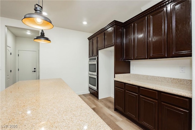 25 Blue Valley Dr, Henderson, NV 89002 - kitchen featuring dark brown cabinetry, double oven, pendant lighting, light wood-style flooring, and recessed lighting