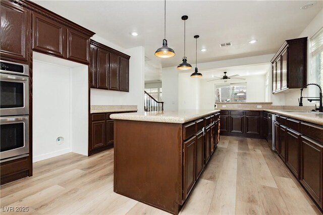 25 Blue Valley Dr, Henderson, NV 89002 - kitchen featuring a sink, double oven, light wood-style floors, a ceiling fan, and recessed lighting