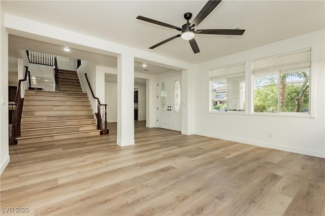 25 Blue Valley Dr, Henderson, NV 89002 - unfurnished living room featuring ceiling fan, baseboards, stairs, and light wood-style floors