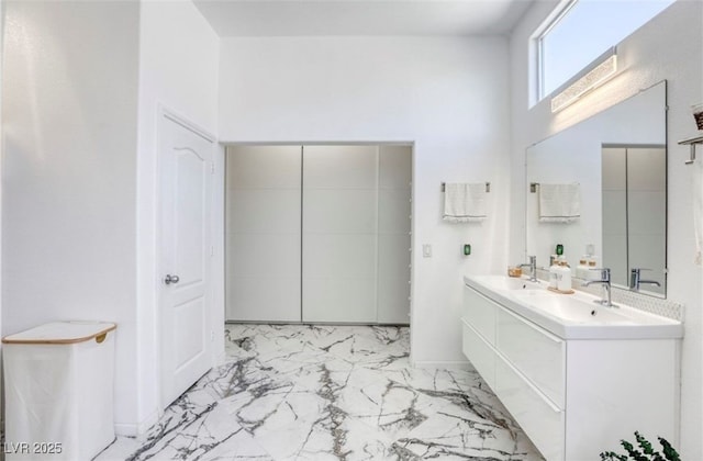 3064 Azure Bay St, Las Vegas, NV 89117 - bathroom with marble finish floors, double vanity, and a high ceiling