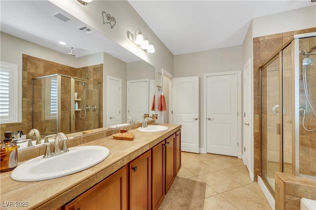 10697 Acacia Park Pl, Las Vegas, NV 89135 - bathroom with a shower stall, tile patterned floors, and double vanity