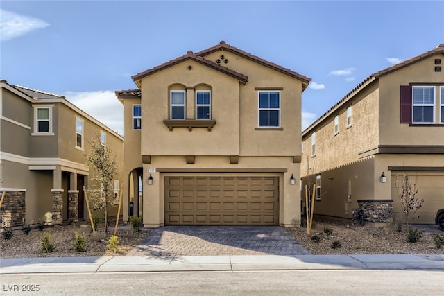 2417 Fasano St, Henderson, NV 89044 - view of front of house with stucco siding, a garage, a tiled roof, and driveway