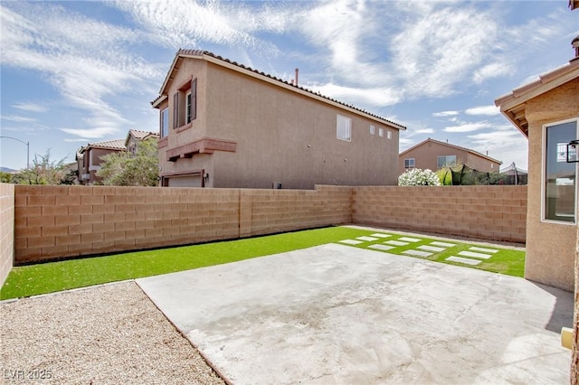 6387 Azurelyn Ave, Las Vegas, NV 89122 - fenced backyard with a patio area