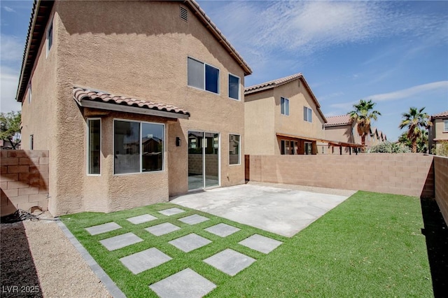 6387 Azurelyn Ave, Las Vegas, NV 89122 - back of property featuring a tiled roof, stucco siding, and a patio