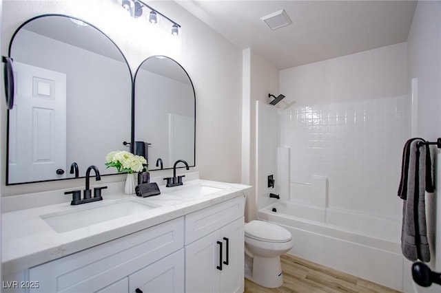 6387 Azurelyn Ave, Las Vegas, NV 89122 - full bath featuring toilet, wood finished floors, double vanity, and shower / bathtub combination