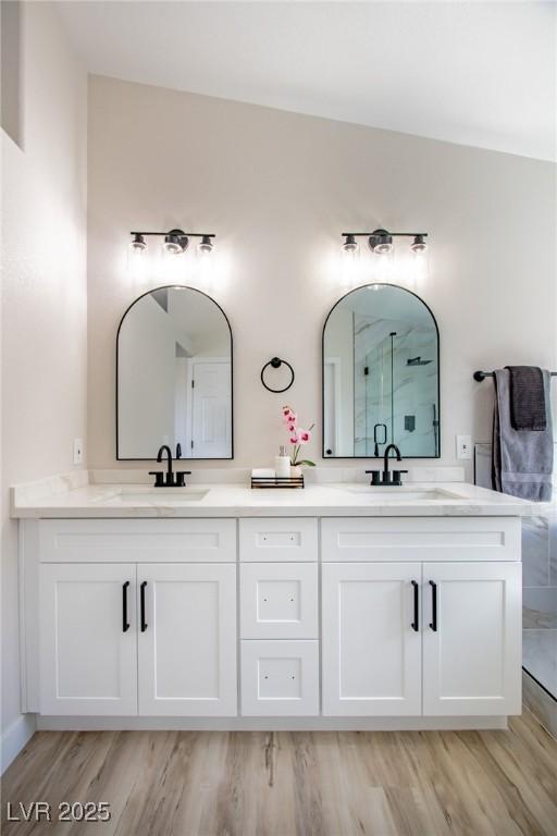 6387 Azurelyn Ave, Las Vegas, NV 89122 - full bathroom featuring double vanity, wood finished floors, and an enclosed shower