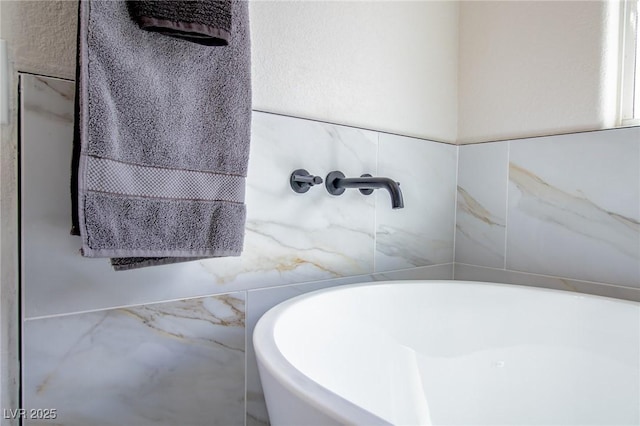 6387 Azurelyn Ave, Las Vegas, NV 89122 - bathroom with a freestanding tub and tile walls