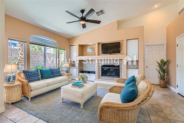 2889 Anteres St, Las Vegas, NV 89117 - living room with a ceiling fan, vaulted ceiling, a glass covered fireplace, and baseboards