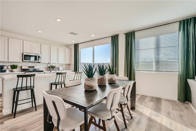 9564 Archer Peak Ct, Las Vegas, NV 89143 - dining room with light wood-type flooring, recessed lighting, and baseboards