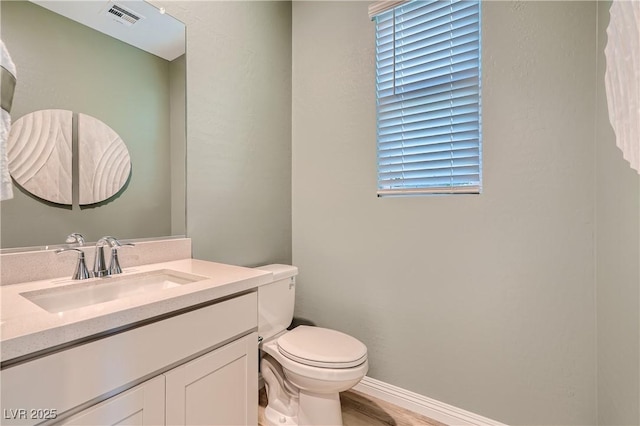 9564 Archer Peak Ct, Las Vegas, NV 89143 - bathroom featuring toilet, vanity, baseboards, and wood finished floors