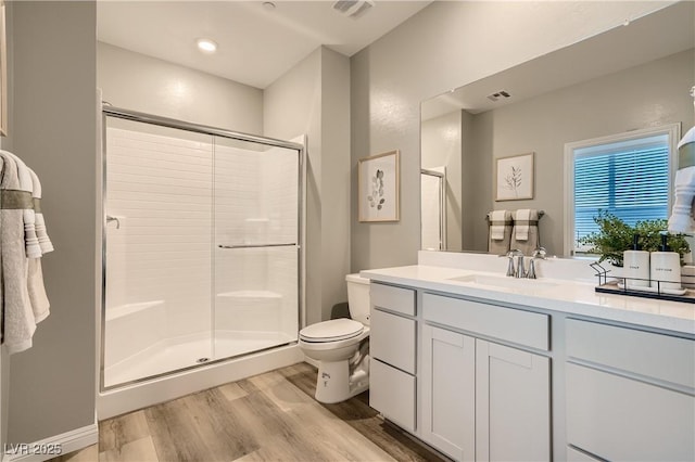 9564 Archer Peak Ct, Las Vegas, NV 89143 - full bathroom featuring a stall shower, wood finished floors, toilet, and vanity