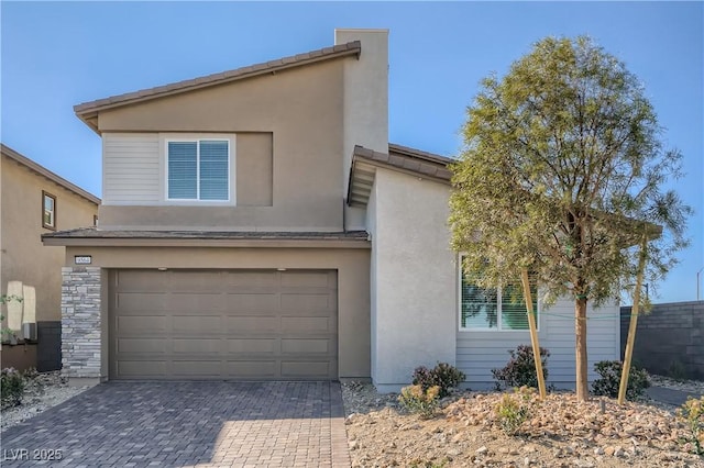 9564 Archer Peak Ct, Las Vegas, NV 89143 - view of front facade with a garage, stucco siding, and decorative driveway