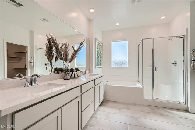 9564 Archer Peak Ct, Las Vegas, NV 89143 - bathroom with a stall shower, a bath, double vanity, and recessed lighting
