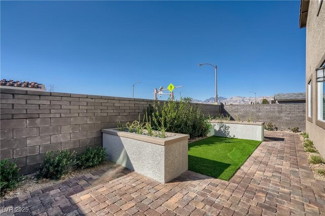 9564 Archer Peak Ct, Las Vegas, NV 89143 - fenced backyard with a patio area and a mountain view