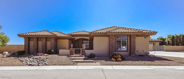 271 E Shelbourne Ave, Las Vegas, NV 89123 - mediterranean / spanish home with concrete driveway, stucco siding, a tiled roof, and a garage