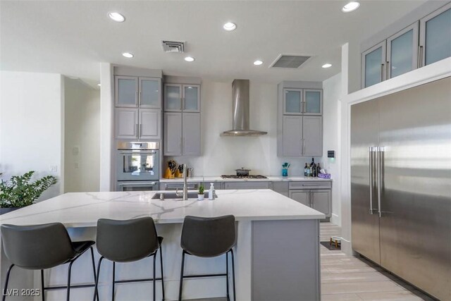 271 E Shelbourne Ave, Las Vegas, NV 89123 - kitchen with appliances with stainless steel finishes, wall chimney range hood, a sink, gray cabinetry, and recessed lighting