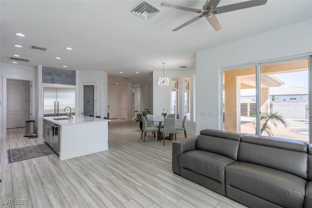 271 E Shelbourne Ave, Las Vegas, NV 89123 - living area with ceiling fan, light wood finished floors, a chandelier, and recessed lighting