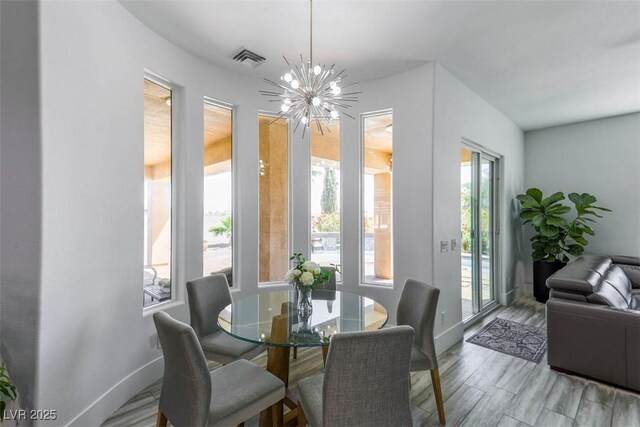 271 E Shelbourne Ave, Las Vegas, NV 89123 - dining space with a chandelier, baseboards, and wood finished floors