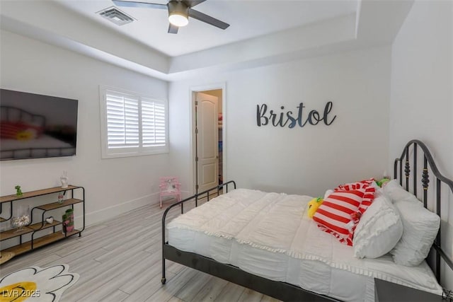 271 E Shelbourne Ave, Las Vegas, NV 89123 - bedroom with a tray ceiling, baseboards, wood finished floors, and ceiling fan