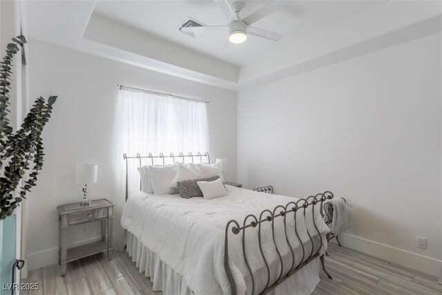 271 E Shelbourne Ave, Las Vegas, NV 89123 - bedroom with light wood finished floors, a raised ceiling, baseboards, and a ceiling fan