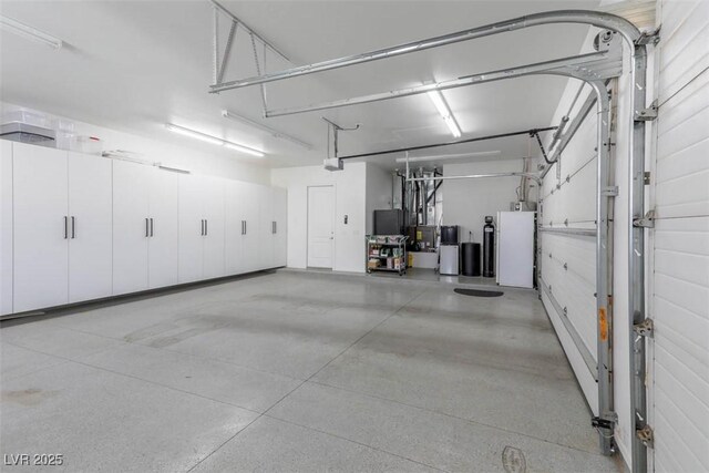 271 E Shelbourne Ave, Las Vegas, NV 89123 - garage featuring a garage door opener and freestanding refrigerator