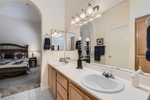 3629 Ferrell St, North Las Vegas, NV 89032 - bathroom with connected bathroom, tile patterned floors, double vanity, and baseboards