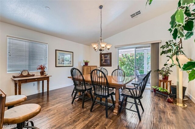 3629 Ferrell St, North Las Vegas, NV 89032 - dining room with a chandelier, vaulted ceiling, dark wood finished floors, and baseboards