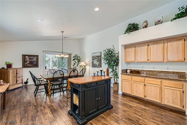 3629 Ferrell St, North Las Vegas, NV 89032 - kitchen with lofted ceiling, light brown cabinetry, dark wood finished floors, decorative light fixtures, and recessed lighting