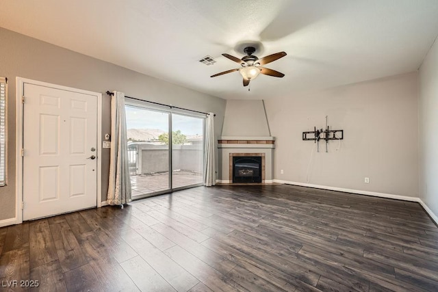 3253 Mystic Ridge Ct, Las Vegas, NV 89129 - unfurnished living room with ceiling fan, dark wood-type flooring, a fireplace, and baseboards