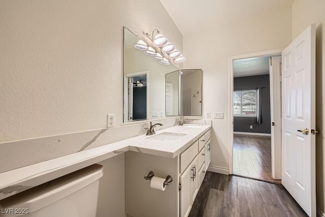 3253 Mystic Ridge Ct, Las Vegas, NV 89129 - bathroom with wood finished floors, toilet, double vanity, and baseboards