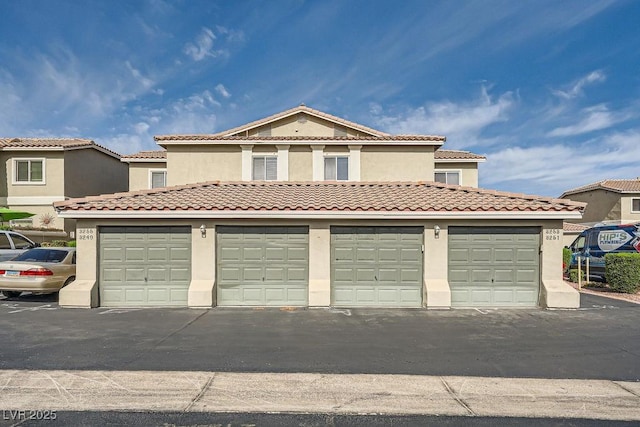 3253 Mystic Ridge Ct, Las Vegas, NV 89129 - view of front facade with community garages and stucco siding