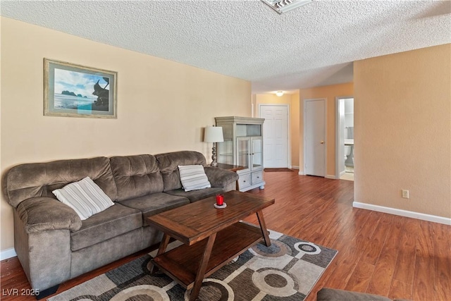 2200 Highpointe Dr Unit 202, Laughlin, NV 89029 - living area featuring wood finished floors, baseboards, and a textured ceiling