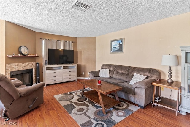 2200 Highpointe Dr Unit 202, Laughlin, NV 89029 - living area featuring a textured ceiling, wood finished floors, and a fireplace