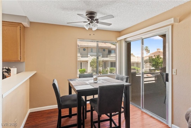 2200 Highpointe Dr Unit 202, Laughlin, NV 89029 - dining room with light wood-style floors, a textured ceiling, ceiling fan, and baseboards