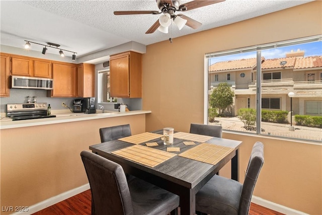 2200 Highpointe Dr Unit 202, Laughlin, NV 89029 - dining area featuring dark wood-style floors, ceiling fan, baseboards, and a textured ceiling